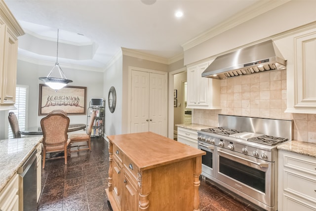 kitchen with a kitchen island, light stone countertops, wall chimney range hood, and stainless steel appliances