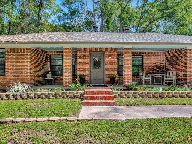 ranch-style home with a patio and a front lawn