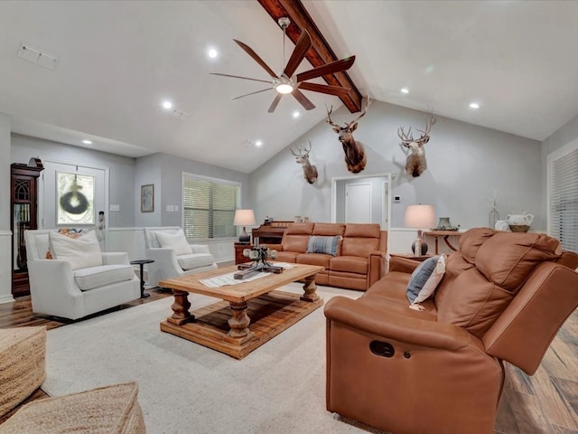 living room with beam ceiling, hardwood / wood-style floors, ceiling fan, and high vaulted ceiling