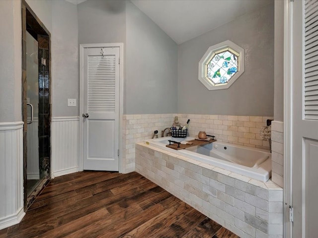 bathroom featuring shower with separate bathtub, lofted ceiling, and hardwood / wood-style floors