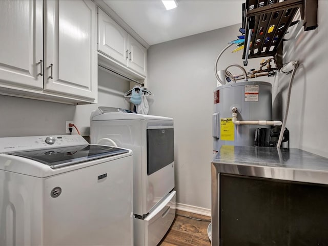 clothes washing area featuring dark hardwood / wood-style flooring, cabinets, and washing machine and dryer