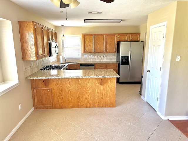 kitchen with ceiling fan, stainless steel appliances, kitchen peninsula, and tasteful backsplash