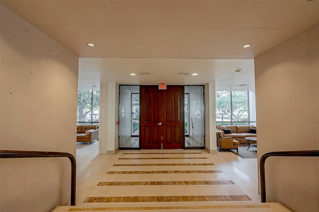 entryway with light tile patterned flooring