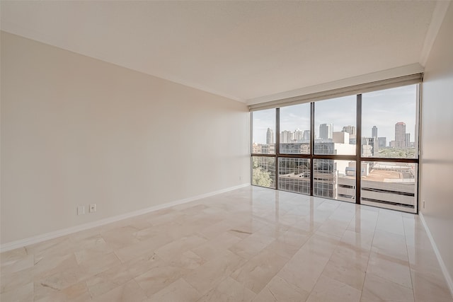 unfurnished room featuring a wall of windows and crown molding