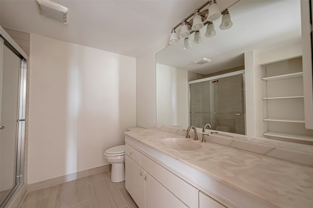 bathroom featuring vanity, toilet, and an enclosed shower