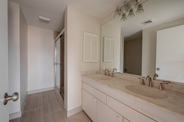 bathroom with vanity, tile patterned floors, and a shower with door