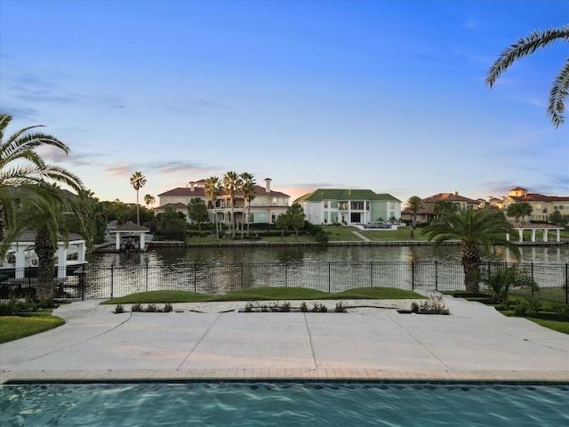 pool at dusk with a water view