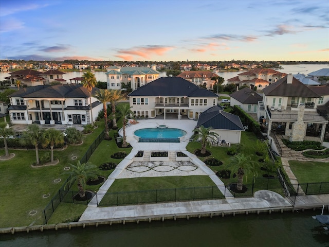 aerial view at dusk with a water view