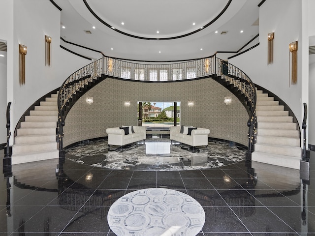 entryway with tile walls and a towering ceiling