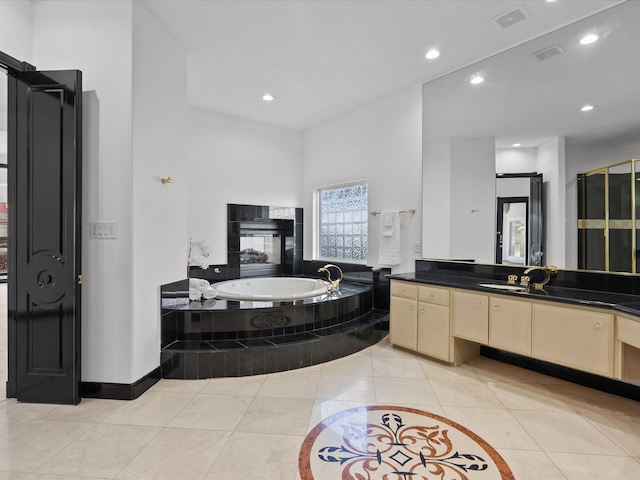 bathroom with vanity, shower with separate bathtub, and tile patterned floors