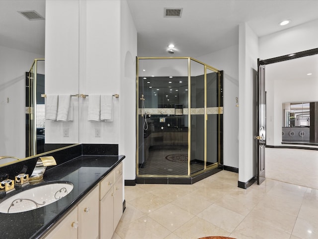 bathroom featuring walk in shower, vanity, and tile patterned floors