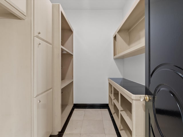 walk in closet featuring light tile patterned flooring