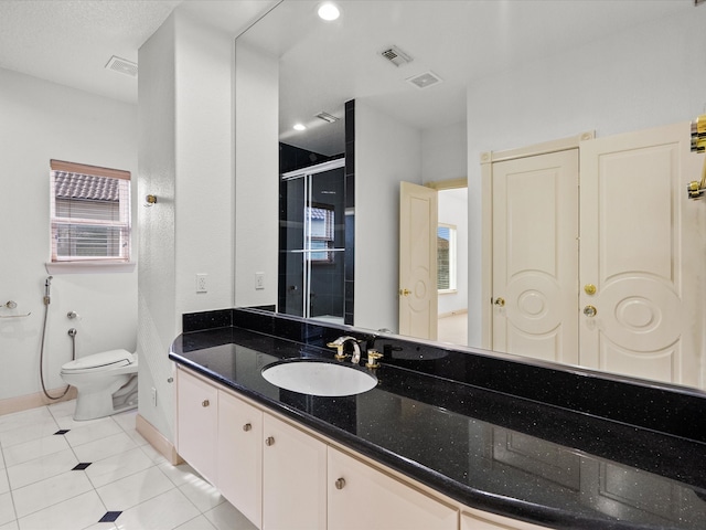 bathroom featuring walk in shower, tile patterned flooring, vanity, and toilet