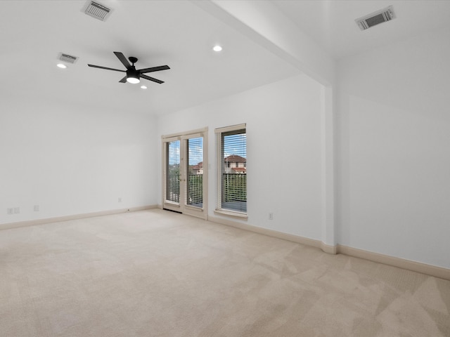 empty room with beam ceiling, ceiling fan, and light colored carpet