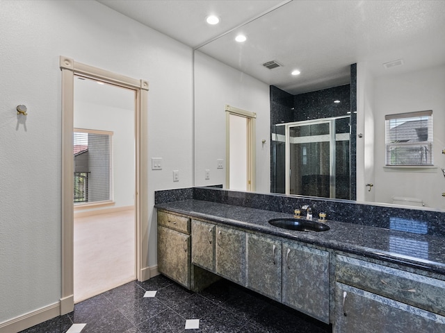 bathroom with walk in shower, vanity, and toilet