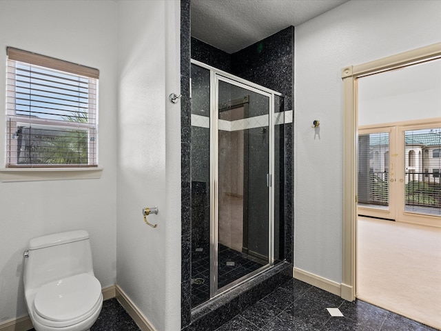 bathroom with walk in shower, toilet, and a healthy amount of sunlight