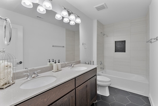 full bathroom featuring tile patterned floors, tiled shower / bath combo, toilet, and vanity