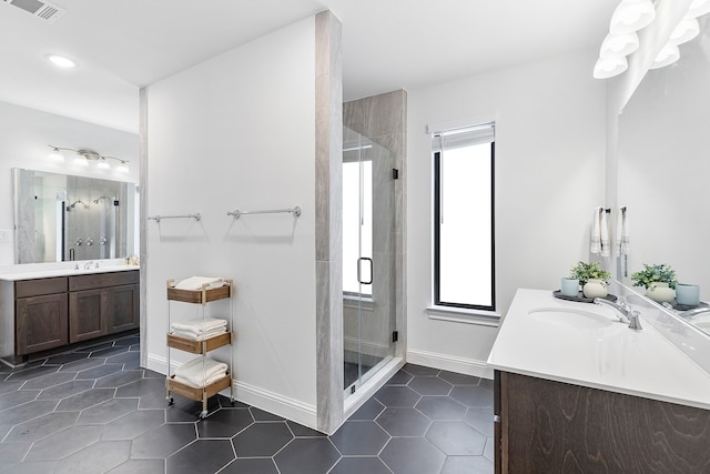 bathroom with tile patterned flooring, vanity, and a shower with shower door