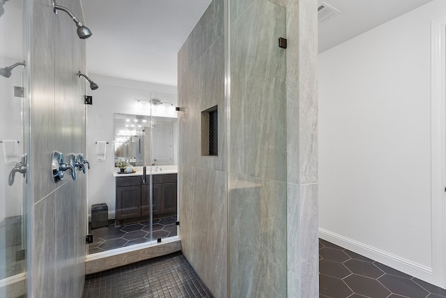 bathroom with tile patterned floors, vanity, and a shower with shower door