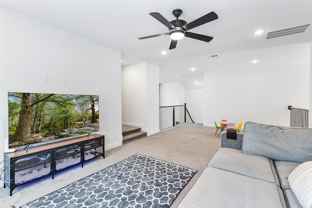 living room featuring ceiling fan and carpet