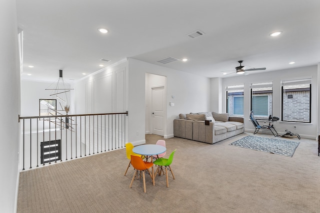 carpeted living room with ceiling fan