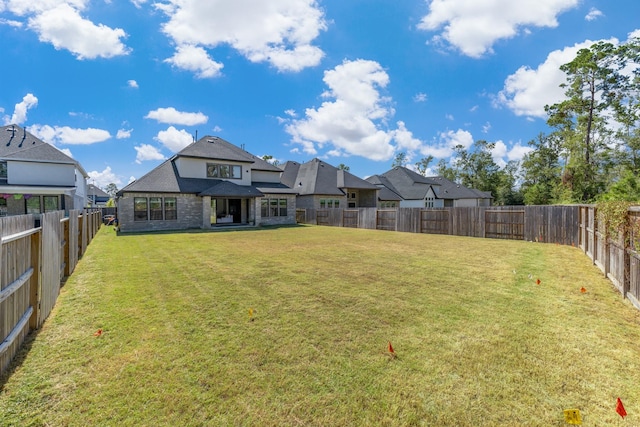 11915 Parsifal Creek Rd, Humble, TX 77346 - back of house with a yard and a fenced backyard