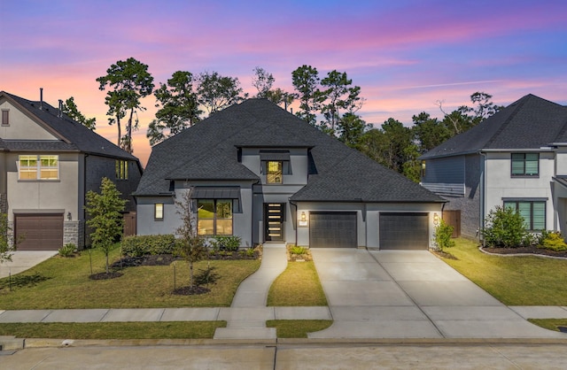 view of front of home with a lawn and a garage