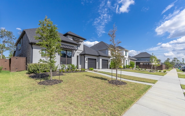 view of front of property featuring a garage and a front lawn