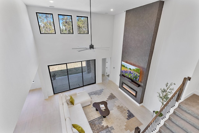 11915 Parsifal Creek Rd, Humble, TX 77346 - living room featuring ceiling fan, stairs, baseboards, recessed lighting, and a high ceiling