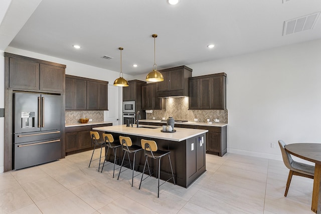 11915 Parsifal Creek Rd, Humble, TX 77346 - kitchen with a kitchen breakfast bar, visible vents, appliances with stainless steel finishes, and decorative backsplash