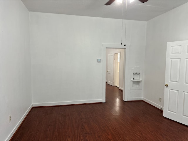 empty room with ceiling fan and dark hardwood / wood-style floors