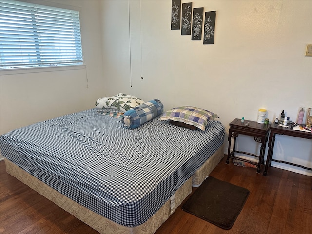 bedroom with dark wood-type flooring