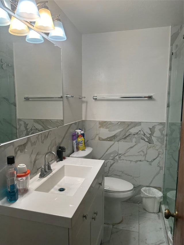 bathroom featuring tile walls, vanity, toilet, and an enclosed shower