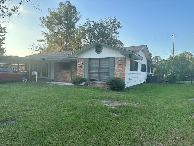 back of property featuring a yard