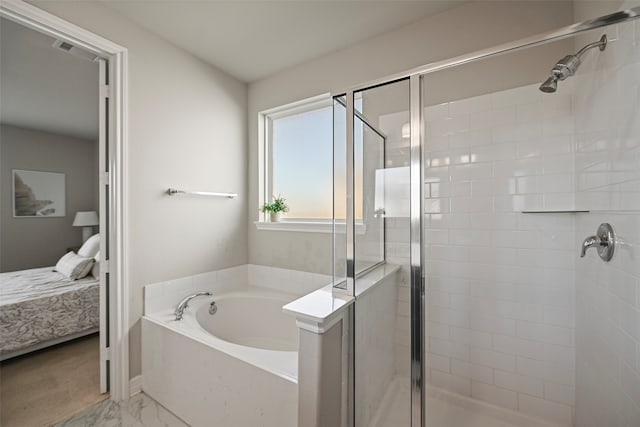 bathroom with shower with separate bathtub