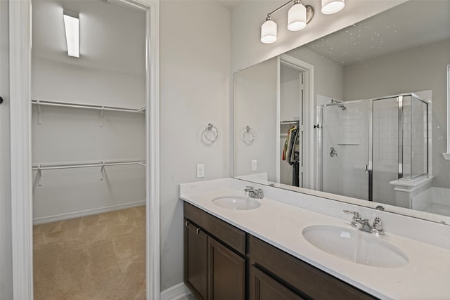 bathroom featuring walk in shower and vanity