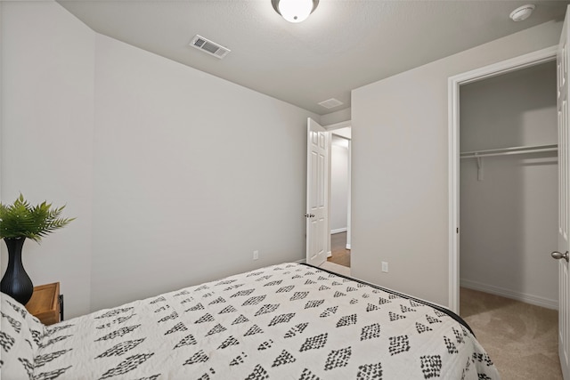 bedroom featuring light carpet and a closet