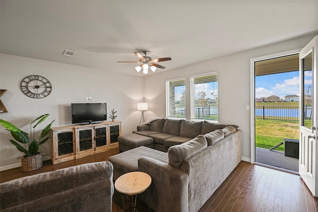 living room featuring dark hardwood / wood-style flooring and ceiling fan