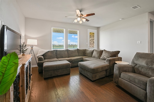 living room with ceiling fan and dark hardwood / wood-style flooring