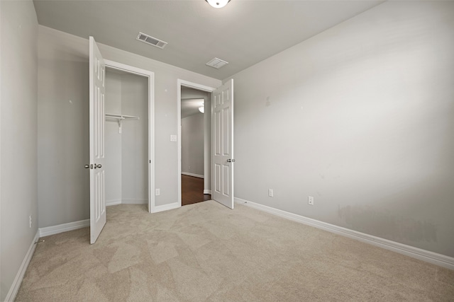 unfurnished bedroom featuring light carpet