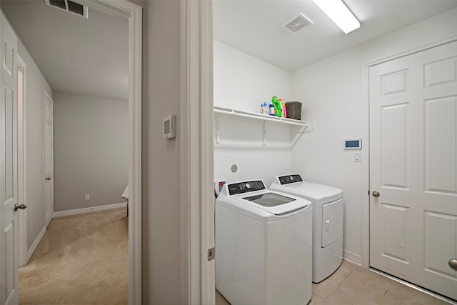 laundry room featuring light colored carpet and independent washer and dryer