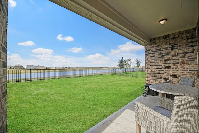 view of yard featuring a water view and a patio area