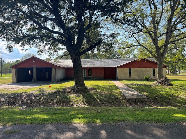 view of side of property with a lawn and a garage