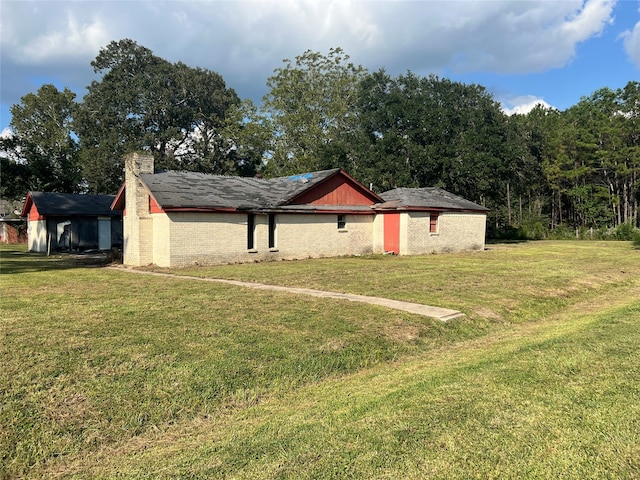 exterior space with a front yard and an outbuilding