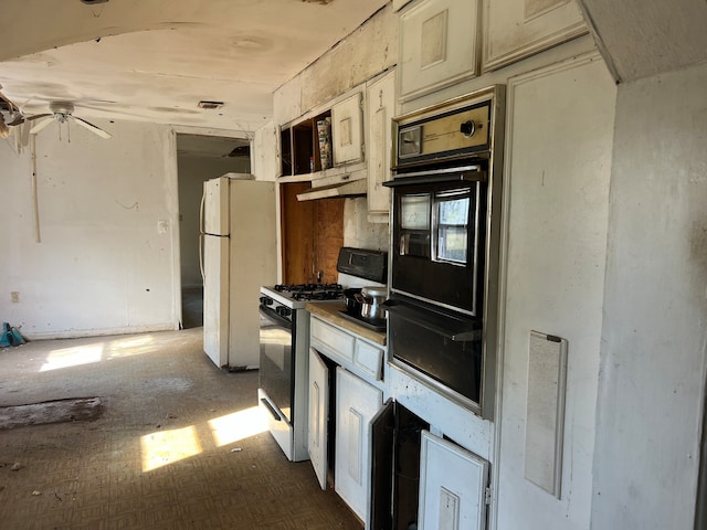 kitchen with cream cabinetry and white appliances