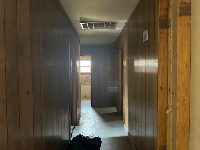 hallway with wood walls