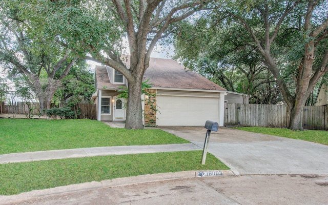 view of front of house with a front yard and a garage