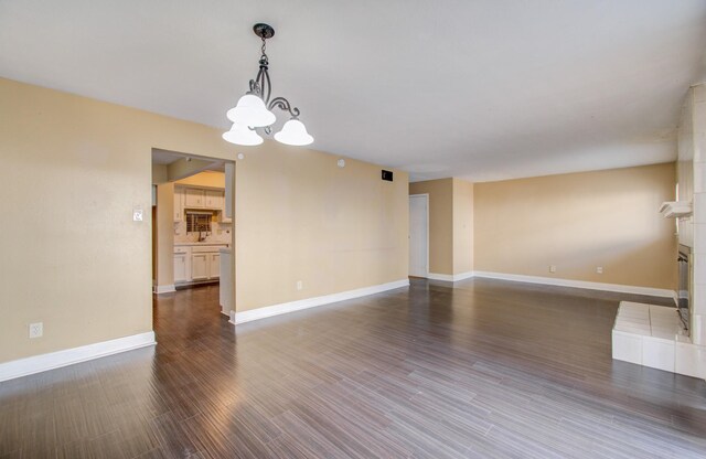 interior space featuring a fireplace, dark hardwood / wood-style floors, and a chandelier