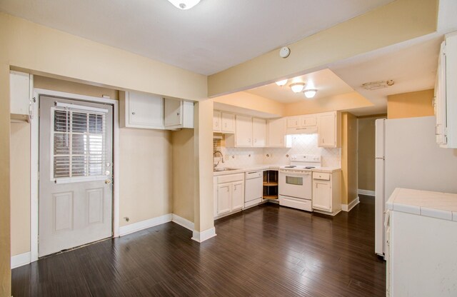 kitchen with white cabinets, white appliances, dark hardwood / wood-style floors, and sink