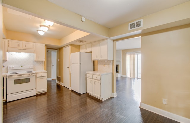 kitchen featuring backsplash, white cabinets, white appliances, and dark hardwood / wood-style flooring